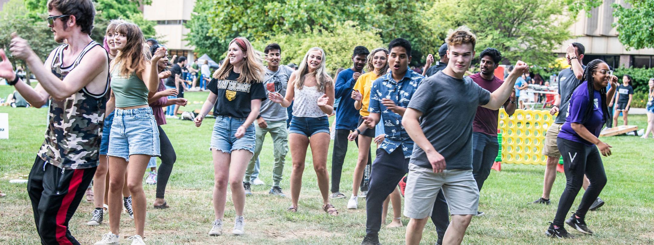 Freshman students at at a campus barbeque lunch