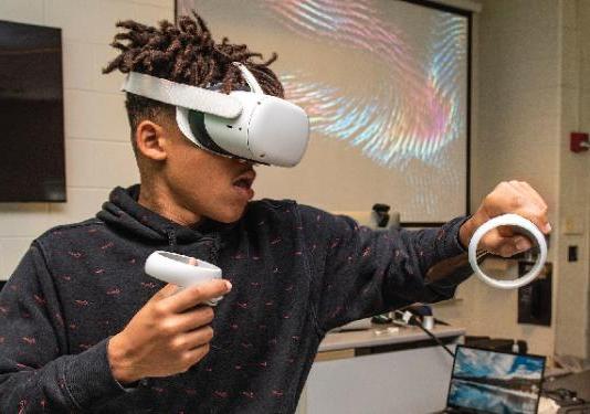 student playing with a VR headset